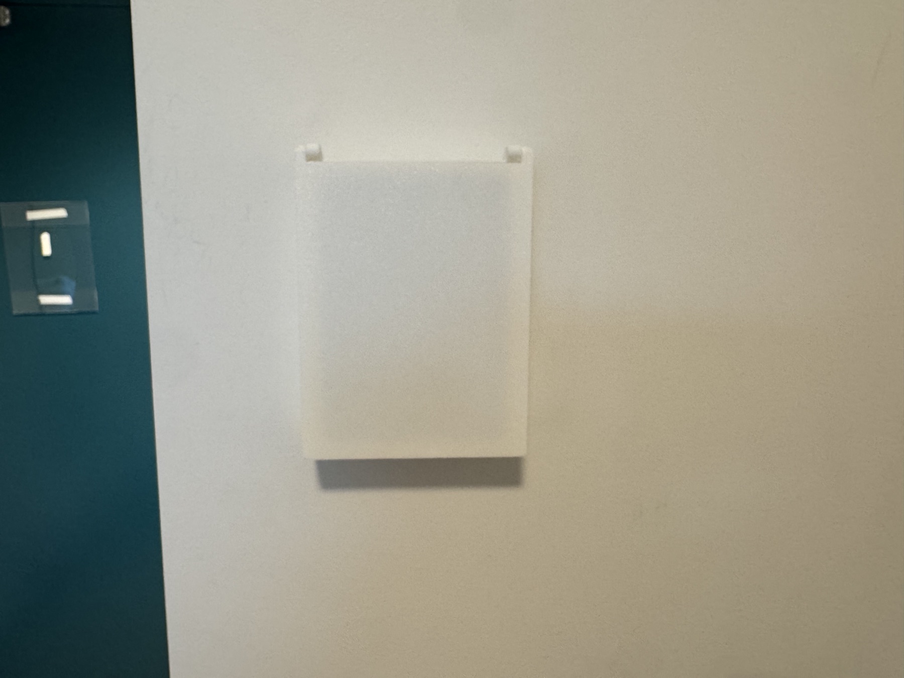 White thermostat cover installed on a wall